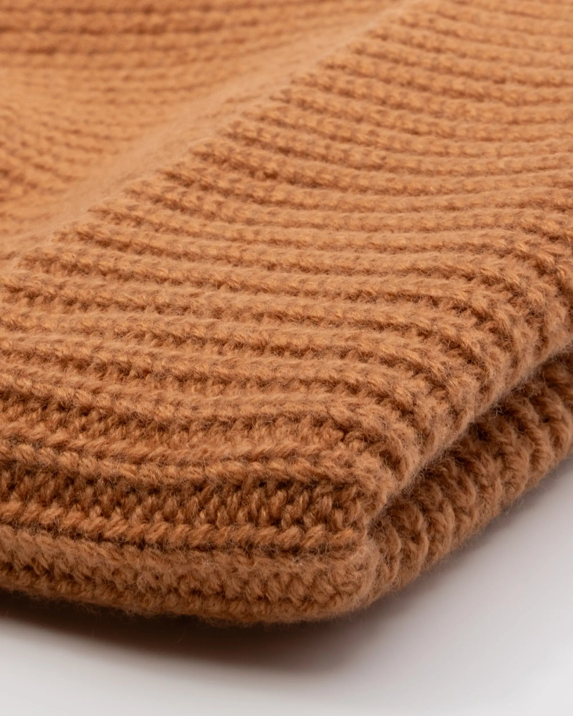 Close up of a light brown beanie