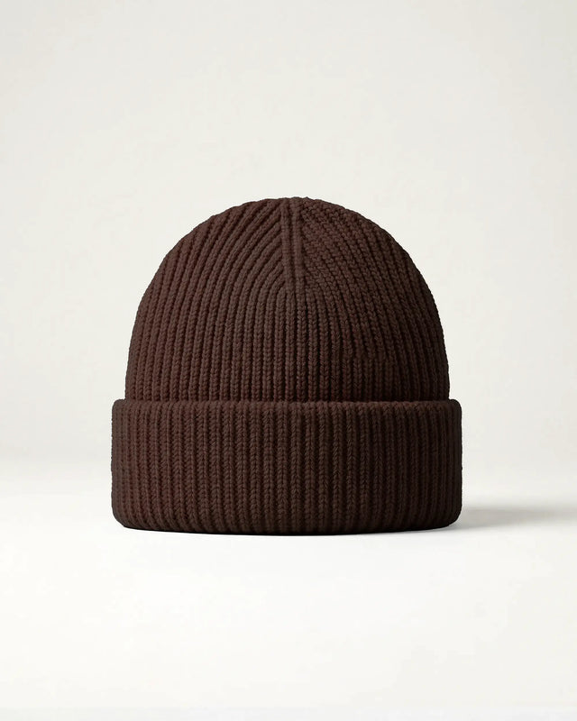 Brown knit beanie on a light beige background