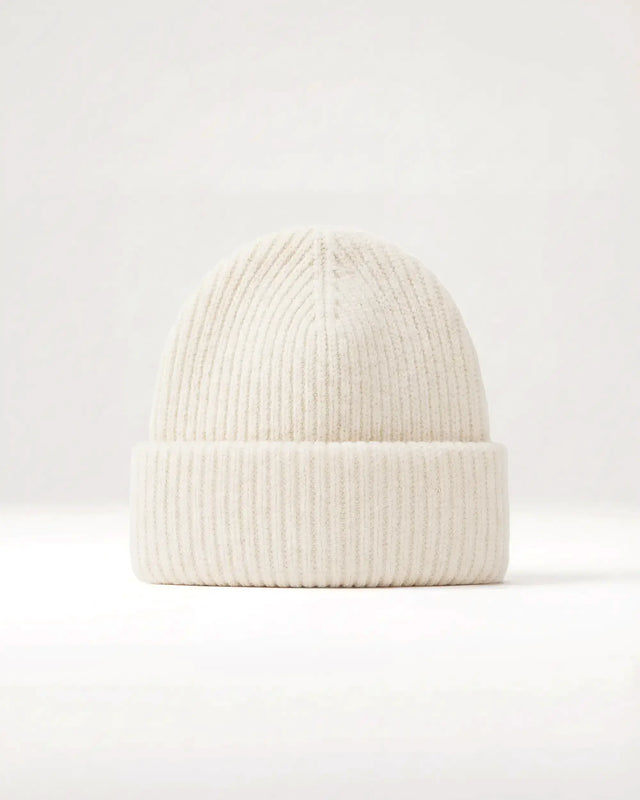 White knit beanie on a light gray background