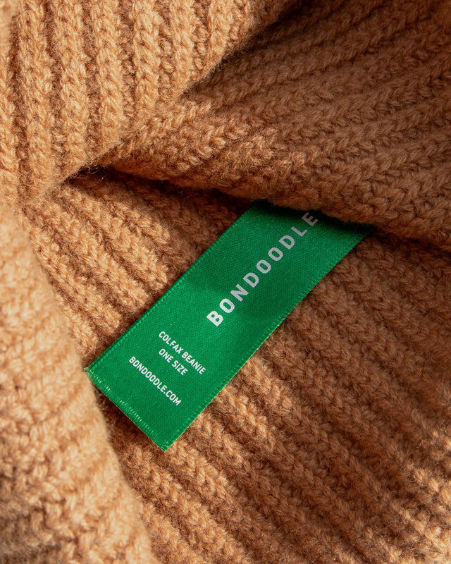 Close-up of a brown textured fabric with a green Bondodole tag.