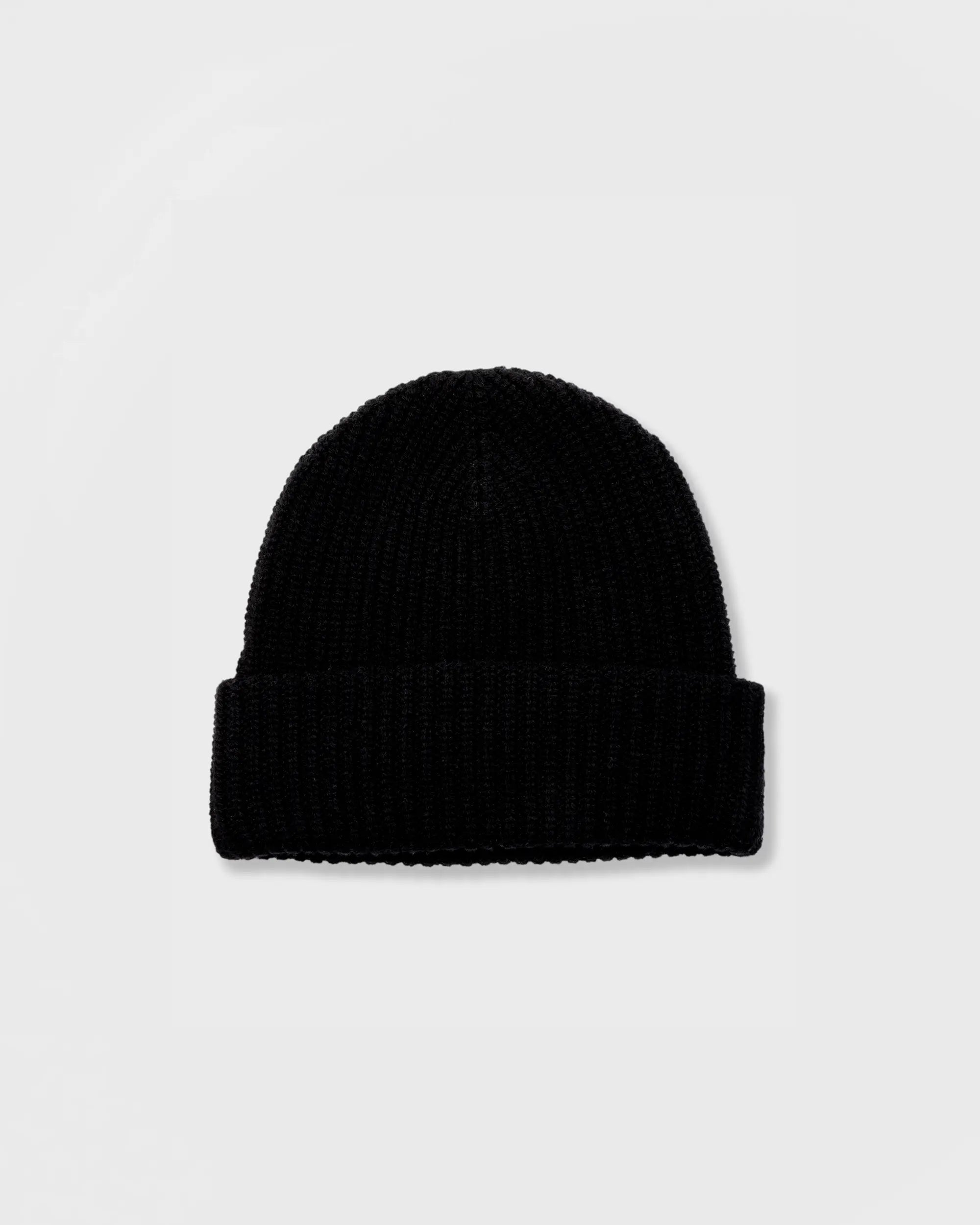 Black beanie hat on a light gray background