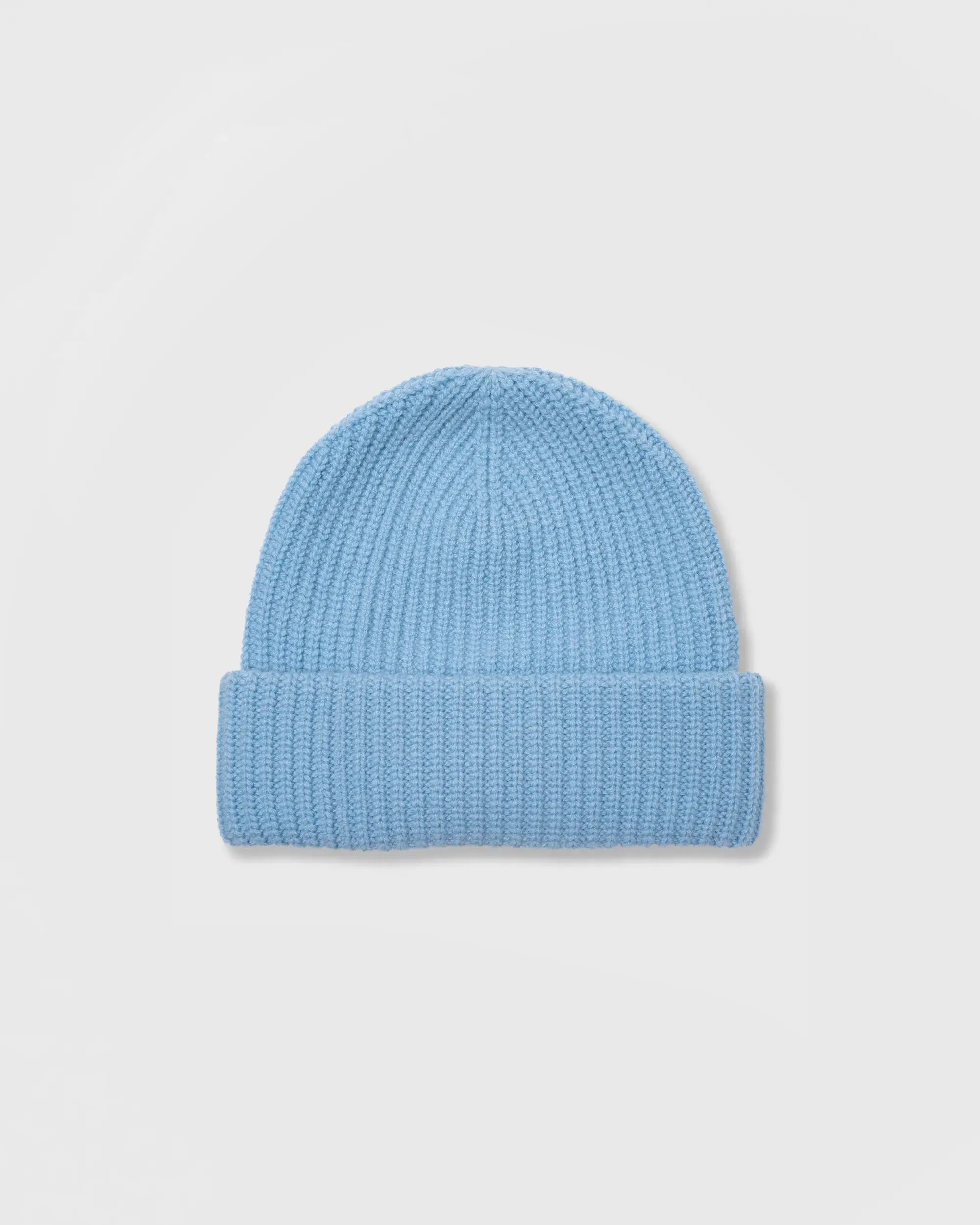 Blue knit beanie on a light gray background