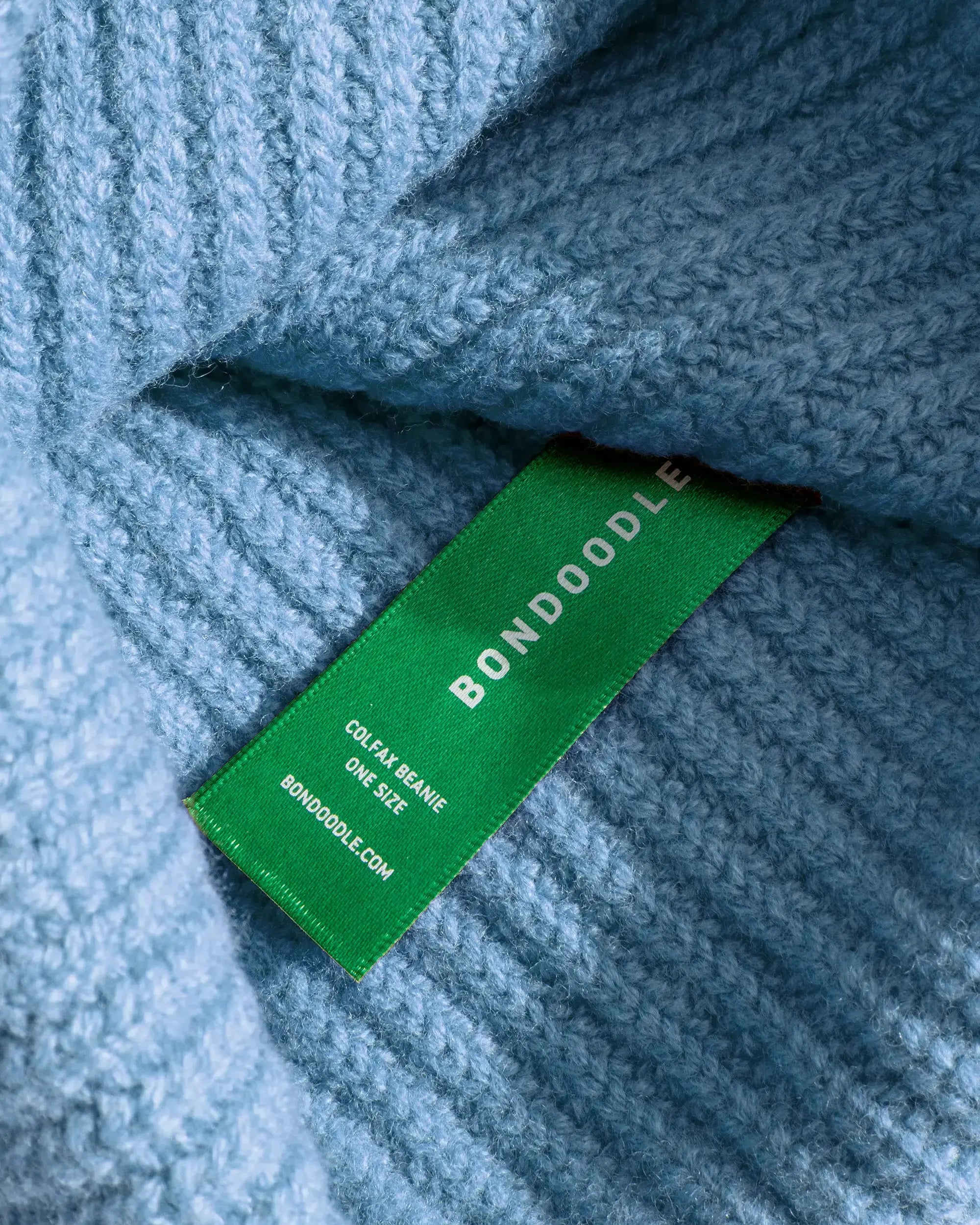 close up of blue knitted merino beanie