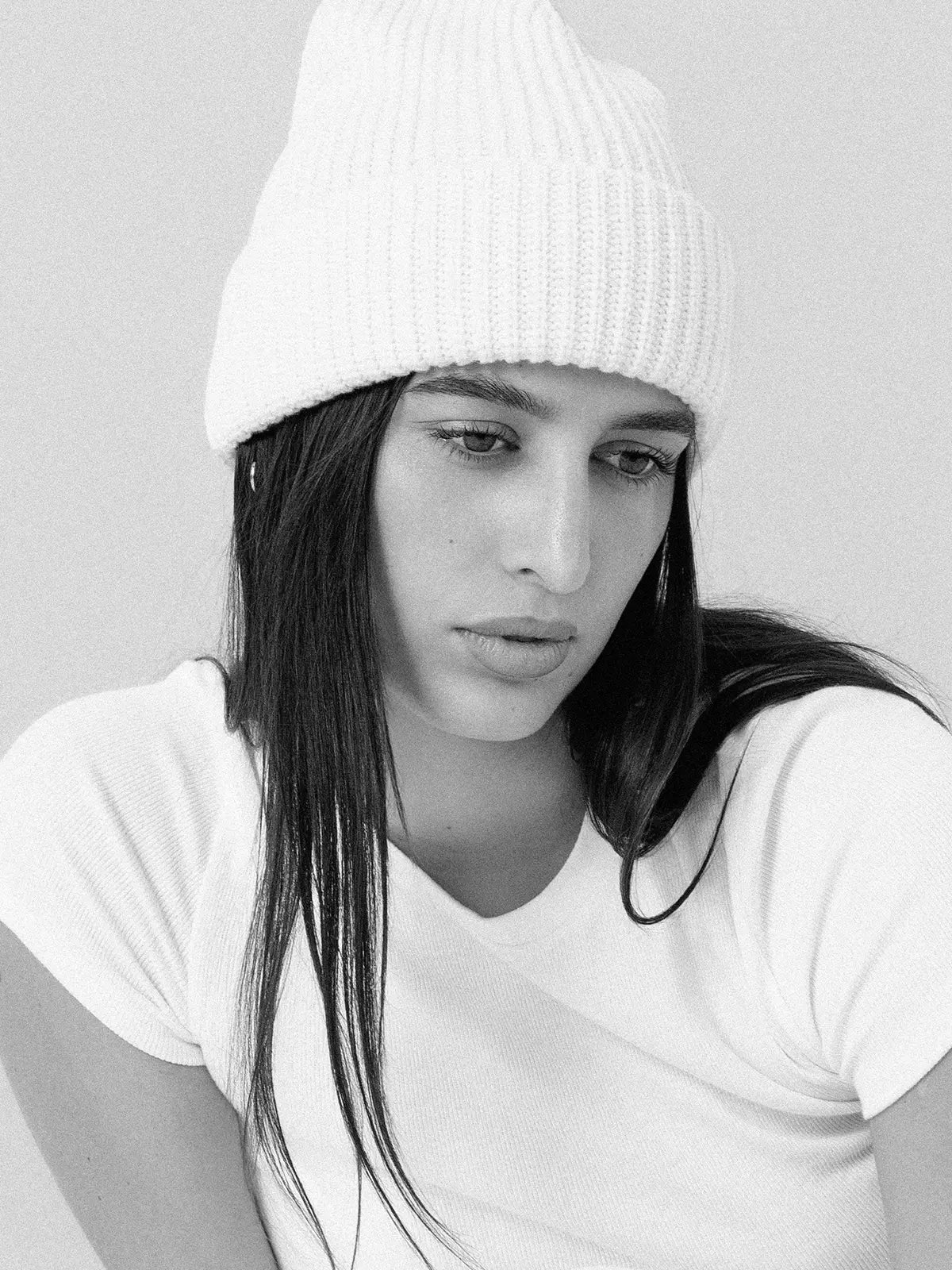 woman wearing white wool beanie in a black and white photograph