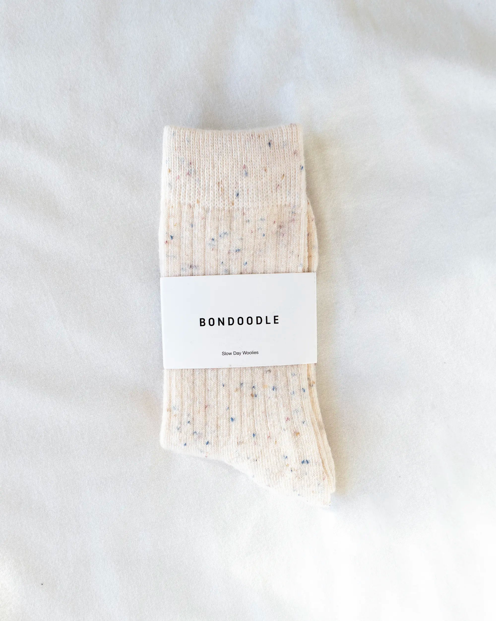Cream merino wool bondoodle crew socks on a white background